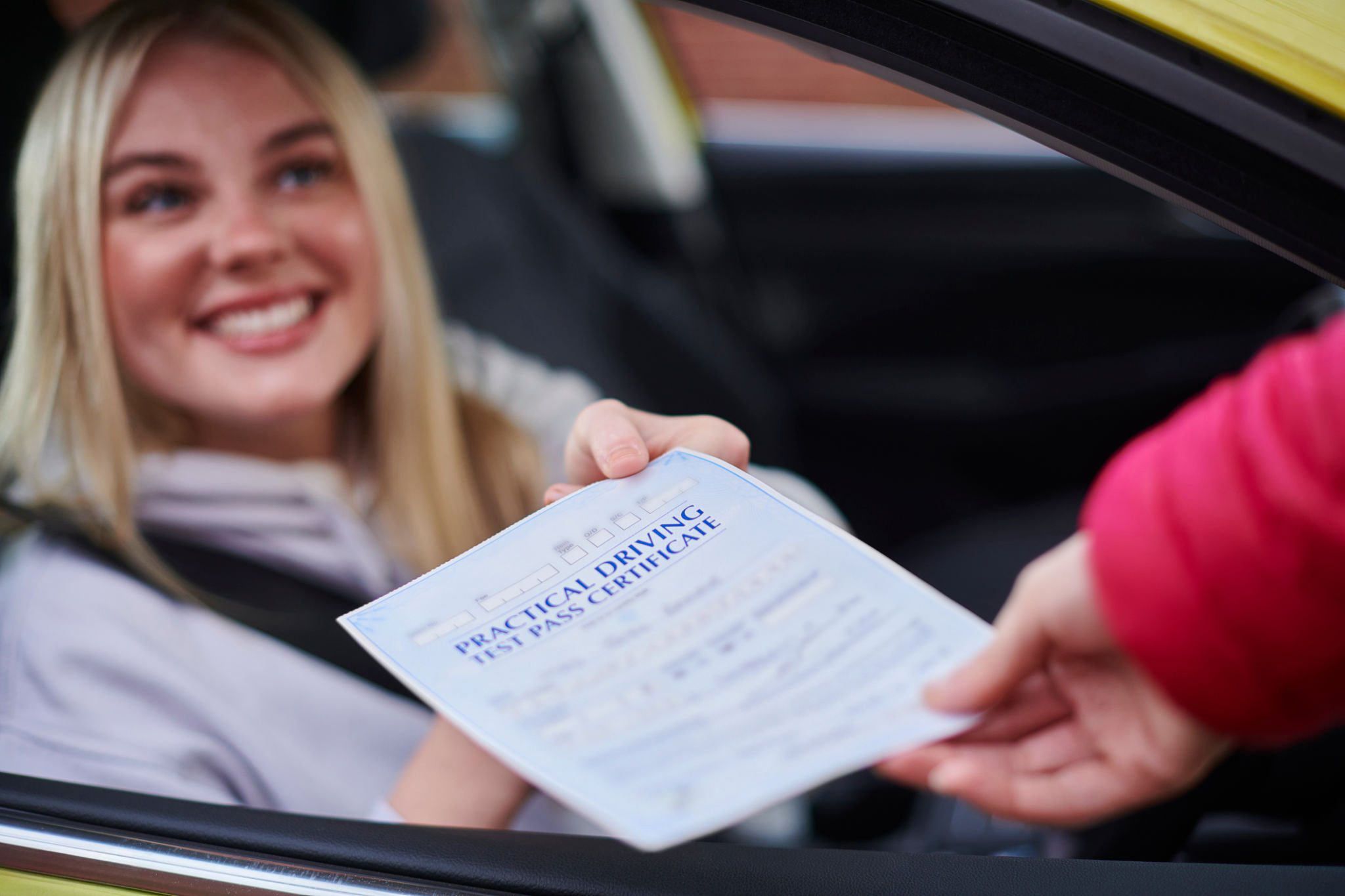 A learner driver passes her automatic driving test